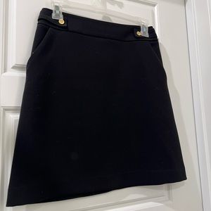 Black high waisted mini skirt with gold buttons